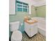 Small bathroom with light green tiled walls and a tub shower at 2303 E Osborne Ave, Tampa, FL 33610