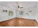 Living room with parquet flooring, window, and ceiling fan at 2303 E Osborne Ave, Tampa, FL 33610