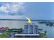 Aerial view of waterfront condo building with pool and tennis courts at 240 Sand Key Estates Dr # 213, Clearwater, FL 33767
