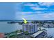 Aerial view of waterfront condo building with pool and tennis courts at 240 Sand Key Estates Dr # 213, Clearwater, FL 33767