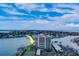 Aerial view of waterfront condo building with tennis courts at 240 Sand Key Estates Dr # 213, Clearwater, FL 33767