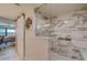 Spa-like bathroom with a large walk-in shower and marble tile at 240 Sand Key Estates Dr # 213, Clearwater, FL 33767