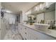 Elegant bathroom with double vanity, marble floors, and modern lighting at 240 Sand Key Estates Dr # 213, Clearwater, FL 33767
