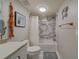 Bathroom with white vanity, marble tile, and bathtub at 240 Sand Key Estates Dr # 213, Clearwater, FL 33767