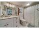 Bathroom with white vanity, marble tile, and shower at 240 Sand Key Estates Dr # 213, Clearwater, FL 33767