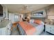Spacious bedroom with light wood floors and coastal decor at 240 Sand Key Estates Dr # 213, Clearwater, FL 33767