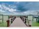 Serene waterfront dock with seating, perfect for enjoying the view at 240 Sand Key Estates Dr # 213, Clearwater, FL 33767
