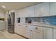 Modern kitchen boasts white cabinets and stainless steel appliances at 240 Sand Key Estates Dr # 213, Clearwater, FL 33767