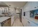 Modern kitchen with white cabinets, marble counters, and stainless steel appliances at 240 Sand Key Estates Dr # 213, Clearwater, FL 33767