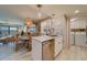 Open kitchen with island seating, stainless steel appliances, and white cabinets at 240 Sand Key Estates Dr # 213, Clearwater, FL 33767
