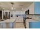 Modern kitchen with white cabinets, stainless steel appliances, and quartz countertops at 240 Sand Key Estates Dr # 213, Clearwater, FL 33767