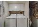 Laundry room with washer, dryer, and overhead cabinets at 240 Sand Key Estates Dr # 213, Clearwater, FL 33767
