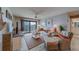 Relaxing living room with water views, wicker furniture, and coastal decor at 240 Sand Key Estates Dr # 213, Clearwater, FL 33767
