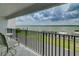 Stunning balcony view overlooking the water, boats, and lush landscape at 240 Sand Key Estates Dr # 213, Clearwater, FL 33767