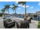 Picturesque backyard with a sparkling pool, fire pit, and waterfront access, creating a perfect outdoor oasis at 2502 S Dundee St, Tampa, FL 33629