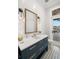 Powder bathroom featuring stylish vanity with gold hardware, designer mirror, and access to outdoor spaces at 2502 S Dundee St, Tampa, FL 33629