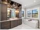 Elegant bathroom with a soaking tub, walk-in shower, and custom cabinets at 2502 S Dundee St, Tampa, FL 33629