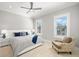 Bright bedroom with a ceiling fan, two windows and luxury vinyl flooring at 2502 S Dundee St, Tampa, FL 33629
