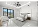 Spacious primary bedroom with a decorative ceiling fan, stylish decor, and private balcony access at 2502 S Dundee St, Tampa, FL 33629