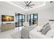 Primary bedroom boasts large windows and comfortable seating area, with scenic waterfront views at 2502 S Dundee St, Tampa, FL 33629