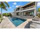 Stunning exterior view featuring a multi-story home, pool, and outdoor kitchen perfect for luxurious waterfront living at 2502 S Dundee St, Tampa, FL 33629