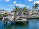 Exterior rear view of a luxury home with boat dock, boat, and Jet Ski at 2502 S Dundee St, Tampa, FL 33629