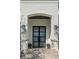 Close up of the front door with two story brick entry and exterior lights at 2502 S Dundee St, Tampa, FL 33629