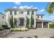 Two story home featuring a manicured lawn, brick driveway, and a two car garage at 2502 S Dundee St, Tampa, FL 33629