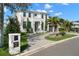 Two story home featuring a manicured lawn, brick driveway, and a two car garage at 2502 S Dundee St, Tampa, FL 33629
