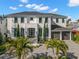 Beautiful two-story home with meticulously landscaped front yard, gray pavers, and black accents at 2502 S Dundee St, Tampa, FL 33629