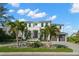 Two story home featuring a manicured lawn, brick driveway, and a two car garage at 2502 S Dundee St, Tampa, FL 33629