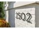 Close-up of the house numbers '2502' on the side of a brick home at 2502 S Dundee St, Tampa, FL 33629