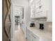Butler's pantry with custom glass cabinets, wine storage, and marble countertops at 2502 S Dundee St, Tampa, FL 33629