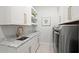 Convenient laundry room with marble countertops, custom cabinets, and modern washer and dryer at 2502 S Dundee St, Tampa, FL 33629
