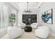 A stylish living room featuring a wine cellar, modern chandelier, and comfortable seating at 2502 S Dundee St, Tampa, FL 33629