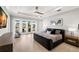 Main bedroom with large windows, decorative dresser, and ceiling fan at 2502 S Dundee St, Tampa, FL 33629