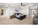 Clean main bedroom with large windows, decorative dresser, and ceiling fan at 2502 S Dundee St, Tampa, FL 33629