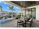 Elegant outdoor dining area with stylish lighting and waterfront views, ideal for hosting memorable gatherings at 2502 S Dundee St, Tampa, FL 33629