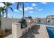 Outdoor kitchen with stainless steel appliances on the waterfront makes entertaining a breeze at 2502 S Dundee St, Tampa, FL 33629