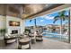 Luxurious outdoor living space with fireplace, tv, pool, and waterfront views for ultimate relaxation and entertainment at 2502 S Dundee St, Tampa, FL 33629