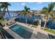 Aerial view of the outdoor pool, patio, and waterfront with boats docked at 2502 S Dundee St, Tampa, FL 33629