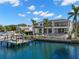 Home's backyard featuring a pool, patio, grass yard, and a dock for watercraft at 2502 S Dundee St, Tampa, FL 33629