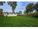 Large backyard with lush green grass and a wooden fence at 2511 Quincy S St, St Petersburg, FL 33711