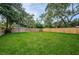 Expansive backyard with a well-manicured lawn enclosed by a wooden fence at 2511 Quincy S St, St Petersburg, FL 33711