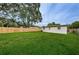Spacious backyard featuring a large green lawn and a wooden fence at 2511 Quincy S St, St Petersburg, FL 33711