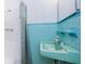 Retro bathroom with teal tile and a single sink vanity at 2511 Quincy S St, St Petersburg, FL 33711