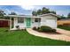 Charming ranch home with green door, landscaped yard, and attached garage at 2511 Quincy S St, St Petersburg, FL 33711