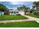 Cute ranch home with a green door and well-manicured lawn at 2511 Quincy S St, St Petersburg, FL 33711