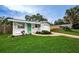 Charming ranch home with a green door and landscaped yard at 2511 Quincy S St, St Petersburg, FL 33711