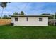 House exterior showcasing a light beige wall and a well-maintained lawn at 2511 Quincy S St, St Petersburg, FL 33711